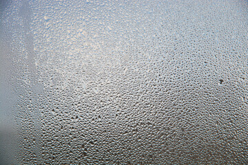 background of water drops or dew on glass in the form of a pattern