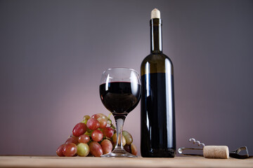 grapes wine bottle and glass with opener