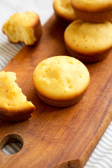 Homemade Cornbread Muffins on a rustic wooden board, side view. Close-up.