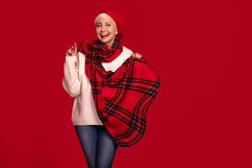 Smiling adult woman in red fashionable scarf.
