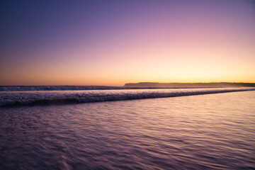 Fototapeta premium waves of the pacific ocean near the shore at sunset