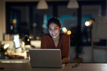 Smiling beautiful business woman having an online video call via laptop computer in the office.