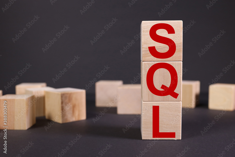 Aufkleber sql - structured query language, text on wood cubes on black background