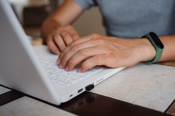 young man freelancer using laptop studying online or working