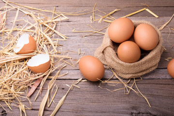 Farm fresh chicken eggs Placed on an old wooden table with straw