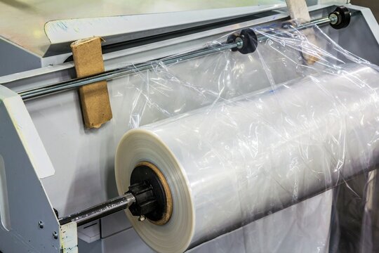 Closeup of a roll of polyethylene film for packing products at the confectionary plant .