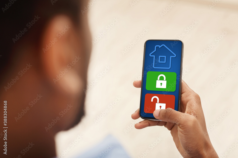 Poster Man using his smartphone with home security application