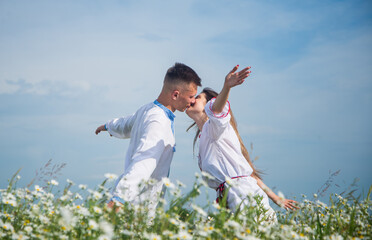 Passion pure love in chamomile field of kissing couple, man and woman