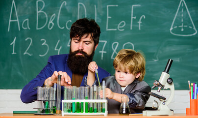 learning chemistry in school laboratory. Back to school. teacher man with little boy. Biology Science lab. Scientist research and experiments father and son at school. With chemistry, we can