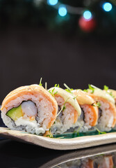 Delicious sushi rolls with shiny blurred background.