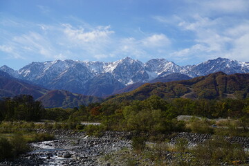 Fototapeta na wymiar Autumn colorful foliage. mountains have 3 different colors made by nature, white, red, green. 