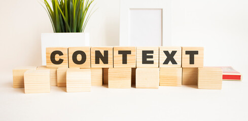 Wooden cubes with letters on a white table. White background.