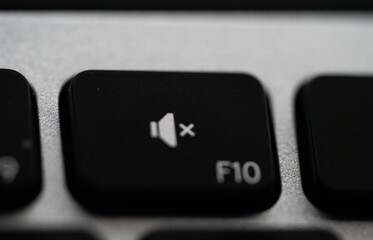 Close up of Keyboard volume mute key on space grey metal. High quality photo