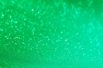 Green glitter bokeh circle glow blurred and blur abstract. Glittering shimmer bright luxury . White and silver glisten twinkle for texture wallpaper and background backdrop.
