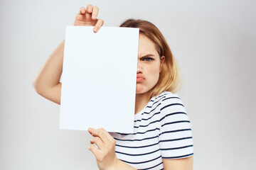 woman holding a sheet of paper in her hands lifestyle striped t-shirt cropped view Copy Space