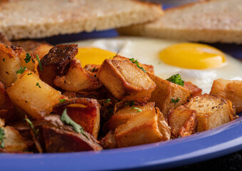 Image of a typical American breakfast. Sausage, eggs and potatos.