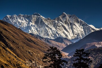 Beautiful view of mountain wall and snowcapped peaks of the Himalayas. Nepal. Bright autumn sky.