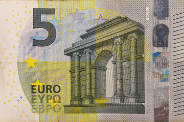 5 EURO extreme closeup on a banknote and number five.