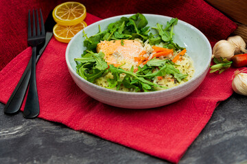 Delicious fillet of cod fish with carrots, leeks and mushrooms in white plate ready to be served