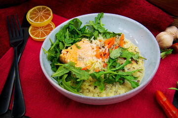Delicious fillet of cod fish with carrots, leeks and mushrooms in white plate ready to be served