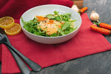 Delicious fillet of cod fish with carrots, leeks and mushrooms in white plate ready to be served