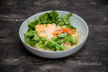 Delicious fillet of cod fish with carrots, leeks and mushrooms in white plate ready to be served