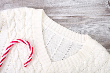 White warm winter knitted sweater, pullover with christmas red decorations on it, winter shopping, sale and discount concept
