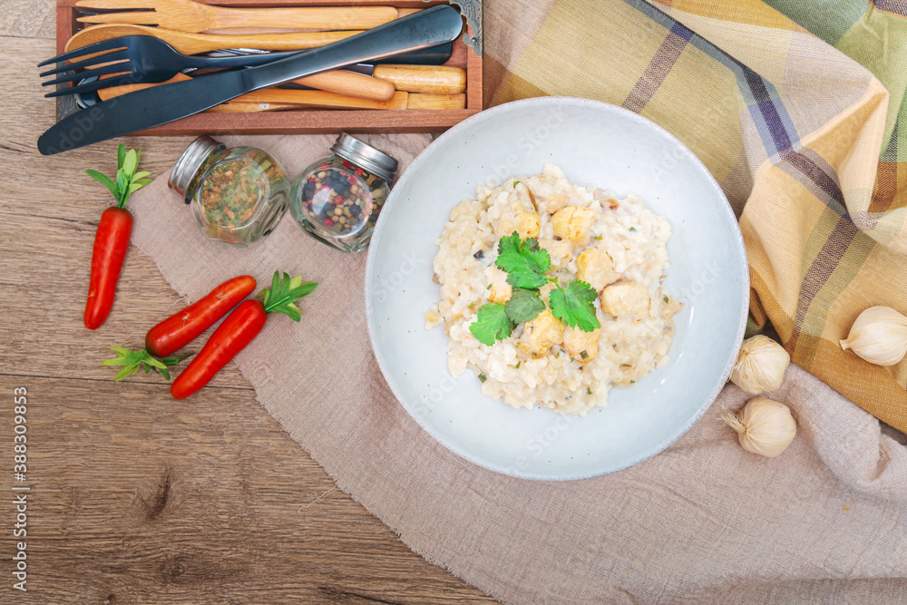 Wall mural Risotto with fresh cream, salted chicken, rehydrated chips and mushrooms