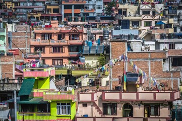 Closeup of colorful houses with flags, flowers on the balconies, solar panels and clothes in a...