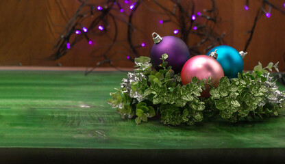 Close-up of Christmas balls on decorative branches with a wooden background. Banner for Christmas and New Year