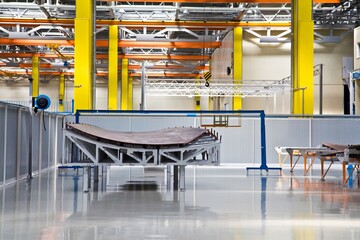 A part of a plane's wing in modern bright colorful assembly hall (shop) in Russia.