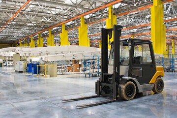 New self propelled lifting platform inside a modern assembly shop full of equipment.