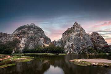Fototapeta na wymiar Khao Ngu Stone Park, limestone mountain on lake and colorful sky at sunset in Ratchaburi