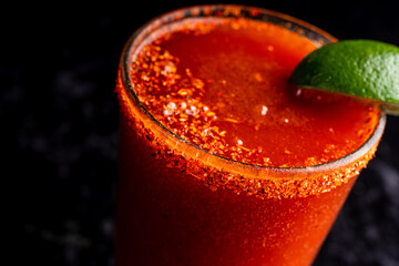 A delicious red cocktail, margarita, bloody mary with tahini and lime. © strotter13