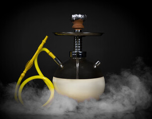 East smoking hookah. Arabian shisha. dark background with smoke