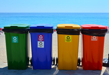 Selective collection of garbage colored containers. Yellow, green, blue and red recycle bins with recycle