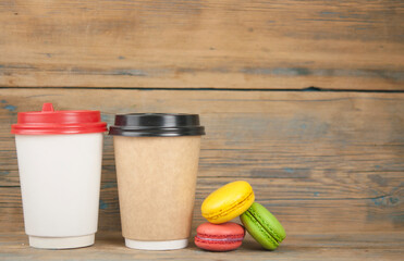  Coffee take away with macaroons on wood table