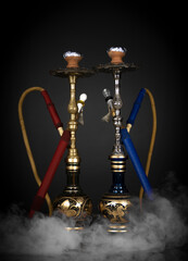 East smoking hookah. Arabian shisha. dark background with smoke