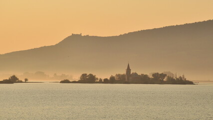 foggy morning on the lake with the church