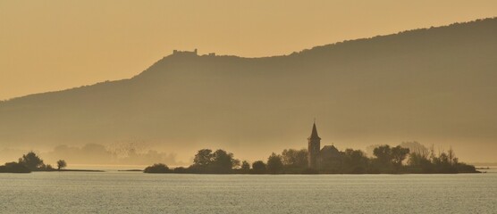 foggy morning on the lake with the church