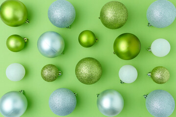 flat lay with christmas balls on green background