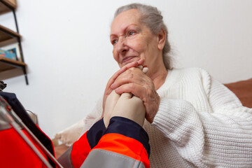 a paramedic conducts a medical examination on an old woman