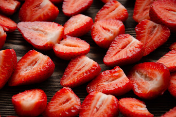 red raw fresh strawberries on wooden background, close view 