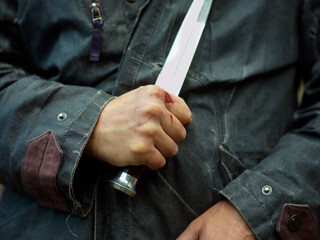 Blood on hand and knife