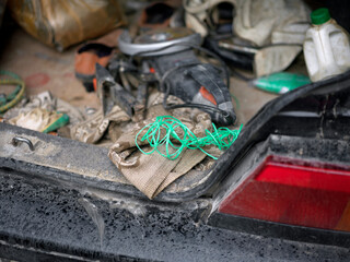 messy car trunk with handtools