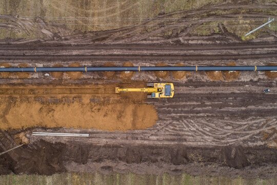 aerial photograph of the laying pipe of large diameter in clay soil. Autumn