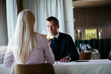 Handsome businessman drinking wine. Businessman enjoying in the restaurant