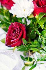 Bouquet of flowers bright red roses and white daisies, macro photo floristry, shop advertising and...