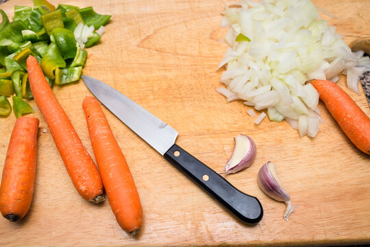 Healthy Diet with fresh vegetables. peppers, carrots, garlic and oinons. wooden background