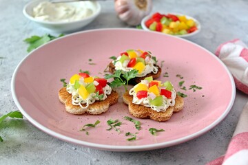 Canape or crostini with toasted bread, light cheese and colorful bell pepper. Top view with copy space.